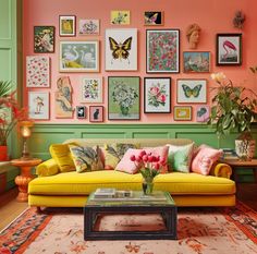 a living room filled with furniture and lots of pictures on the wall above it's coffee table