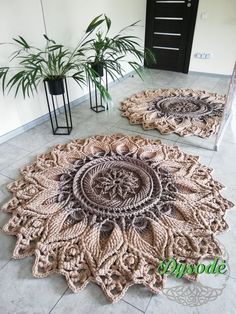 two circular rugs on the floor in front of a plant