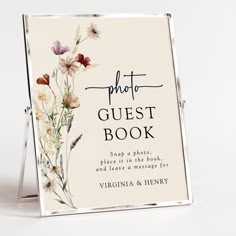 a sign with flowers on it that says photo guest book