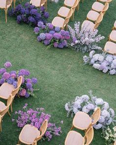 chairs and tables are arranged in the middle of a flower garden with purple flowers around them