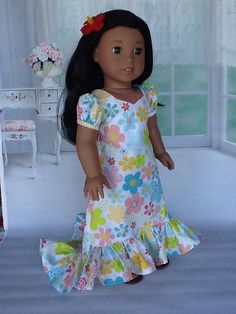 the doll is wearing a dress with flowers on it