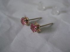 14K Pink Stone Stud Yellow Gold Earrings Vintage Karat KT Solid Pierced Post Materials: 14K solid gold metal marked (14K), (pink stones - do not know what they are made from) with plastic/silicone post backs Condition: excellent vintage Measures - 5mm x 5mm x 4mm Maker's mark - P Questions welcome. Fine Jewelry Hallmarked Pink Earrings, Pink Hallmarked Fine Jewelry Earrings, Hallmarked Pink Fine Jewelry Earrings, Pink Earrings With Prong Setting For Anniversary, Pink Prong Set Earrings For Anniversary, Pink Fine Jewelry Earrings, Pink Earrings For Anniversary, Pink Round Earrings With Prong Setting, Pink Prong Set Round Earrings