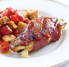 a white plate topped with meat and vegetables