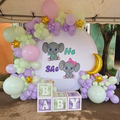 an elephant themed baby shower with balloons, blocks and stars on the ground next to it