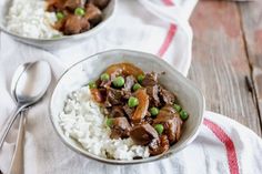 two bowls filled with rice and meat on top of a table