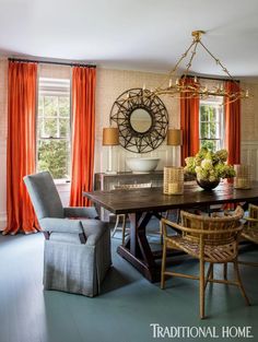 an elegant dining room with orange drapes