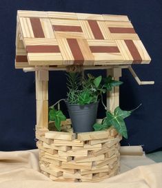 a potted plant sitting on top of a wooden structure with plants growing out of it