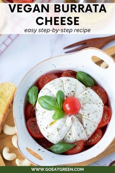 a bowl filled with tomatoes and cheese on top of a cutting board next to bread