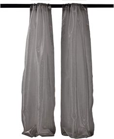 two gray curtains hanging from a metal rod