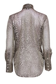 Unleash your wild side this holiday season with a striking blouse from Equipment. Featuring a playful metallic gold leopard print and chic tie neckline, this sheer gem is both fierce and fashionable! Tuck it into some leather pants and throw on some booties for a sleek look that's sure to turn heads at any holiday party. Size XS Shell 55% Lurex, 45% Polyester Contrast 100% Silk Button-up front Buttoned cuffs Tie-neck Bust 39" Waist 36" Shoulder to hem 27" Sleeve length 26" Elegant Leopard Print Party Blouse, Chic Leopard Print Blouse For Party, Festive Metallic Blouse, Elegant V-neck Leopard Print Top, Chic Leopard Print Top For Party, Fitted Metallic Blouse For Fall, Chic Leopard Print Party Top, Chic Festive Tops For Workwear, Festive Metallic Elegant Tops