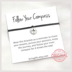 a bracelet that says follow your compass on it with a small anchor charm attached to it