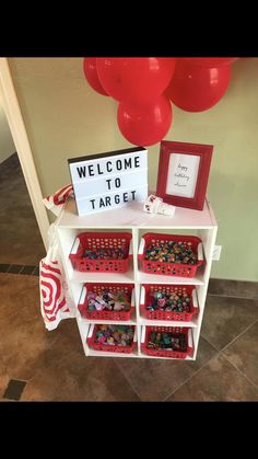 a welcome to target sign on a shelf with baskets and balloons in the background at a children's birthday party