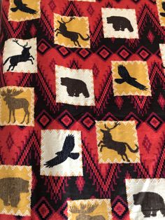 a red and black blanket with animals on it