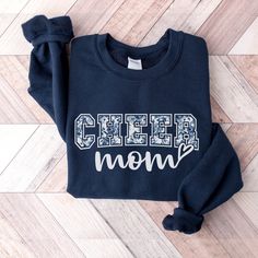 Introducing the perfect gift for all the cheer moms out there or cheer team matching sweatshirts! This unique and stylish crewneck is a must-have for any proud mother of a cheerleader. With its eye-catching design and comfortable fit, it's sure to become your go-to sweatshirt for every cheer event. H O W  -  T O  -  O R D E R  - Be sure to review the size chart in the photos before making your selection. - Select your style/size & color from the drop-down menus. - Click the "Add to Cart" button, then proceed to check out once you have added all of your items. M A T E R I A L S 50% cotton, 50% polyester, Air-jet spun yarn with a soft feel and reduced pilling. S W E A T S H I R T  -  S I Z I N G  All sweatshirts are UNISEX sizing. Lay out your favorite sweatshirt and compare these measuremen Sporty Cotton Sweatshirt For Cheerleading, Cheerleading Letter Print Crew Neck Sweatshirt, Crew Neck Sweatshirt With Letter Print For Cheerleading, Crew Neck Graphic Print Sweatshirt For Cheerleading, Winter Crew Neck Sweatshirt For Cheerleading, Cheerleading Team Name Crew Neck Sweatshirt, School Spirit Cotton Sweatshirt For Cheerleading, Crew Neck Sweatshirt With Team Name For Cheerleading, Cotton Sweatshirt For School Spirit Cheerleading