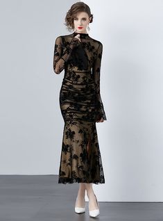 Mystique becomes tangible in this delicately crafted black lace dress that exudes both elegance and sensuality. A sheer overlay with intricate floral patterning cascades over a sleek, form-fitting underlay, creating a dance between concealment and revelation. The full-length sleeves bloom into fluted cuffs, adding a touch of dramatic flair, while the high neckline balances the ensemble with a touch of traditional grace. Perfect for gala events or sophisticated soirées, this dress demands attenti Black Lace Gown, Sleeveless Dresses Casual, Push Up Swimsuit, What Lies Beneath, Printed Tankini, Gala Events, Sheer Overlay, Mermaid Silhouette, Black Lace Dress