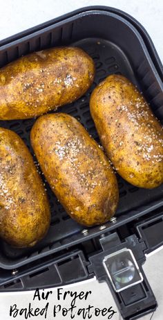 four baked potatoes sitting in an air fryer