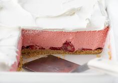 a piece of cake with white frosting and strawberries in it on a plate