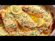 baked salmon with lemons and herbs in a pan