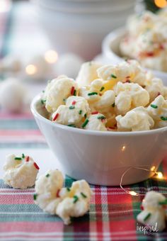 small white bowls filled with candy canes and sprinkles on a table