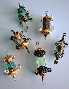 several different types of beaded charms on a white surface