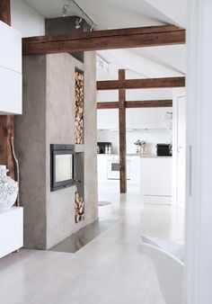 the interior of a modern home with white walls and wood accents on the wall, along with an open door