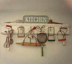 kitchen utensils are hanging on the wall