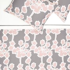 pink and grey floral wallpaper on a white table with two matching placemats