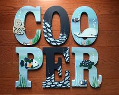 the words cool pier are made out of wood and metal letters with sea creatures on them