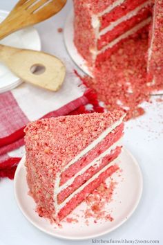 a slice of red velvet cake on a white plate next to the rest of the cake