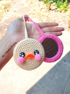 a hand holding a small bird ornament in it's palm