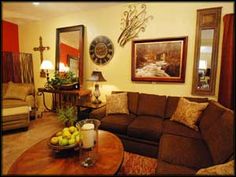 a living room with couches, tables and pictures on the wall in it's center