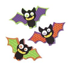 three halloween bats with eyes and fangs on them are cut out to look like bats