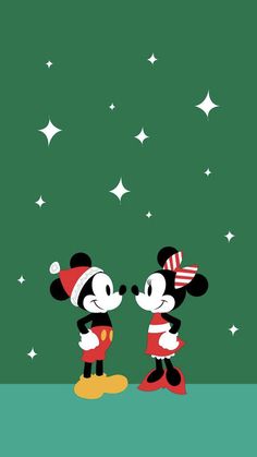 two mickey and minnie mouses standing next to each other in front of the stars