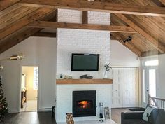 a living room filled with furniture and a flat screen tv mounted on the wall above a fireplace