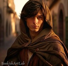 a young man wearing a brown shawl in the middle of an old town street