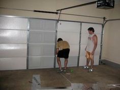 two men standing in front of garage doors