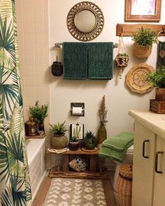 a bathroom with plants and towels hanging on the wall