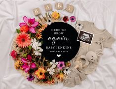 there is a baby announcement surrounded by flowers