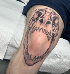 a man's arm with a tattoo on it that looks like a monster head