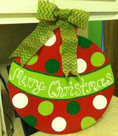 a red and green christmas ornament sitting on top of a table