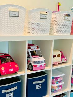 toy cars and trucks are lined up on the shelves in this playroom with storage bins