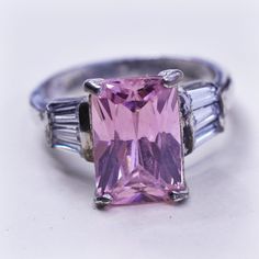 Size 5.75, Vintage Sterling silver fashion ring, 925 silver with emerald cut pink Quartz and clear crystal details, stamped 925 Pink Sterling Silver Crystal Ring With Center Stone, Pink Jewelry With Center Stone And Baguette Cut, Pink Baguette Cut Jewelry With Center Stone, Pink Baguette Cut Rings With Prong Setting, Pink Baguette Cut Ring With Prong Setting, Pink Rectangular Ring With Accent Stones, Pink Rectangular Stone Ring For Anniversary, Fine Jewelry Pink Rectangular Rings, Radiant Cut Pink Ring With Center Stone