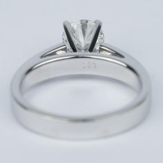 a close up view of a ring with a diamond in it on a white background