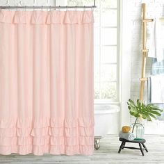 a pink shower curtain in a bathroom