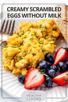 scrambled eggs without milk on a plate with strawberries and blueberries next to it