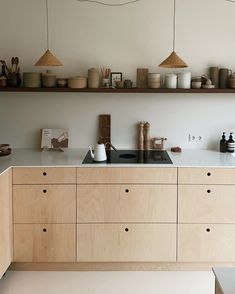 a kitchen with wooden cabinets and white counter tops