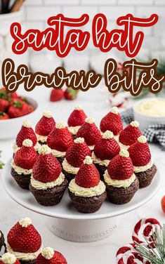 chocolate cupcakes topped with strawberries and whipped cream are on a white plate