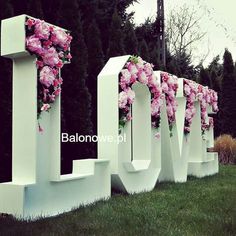 the letters love are decorated with pink flowers