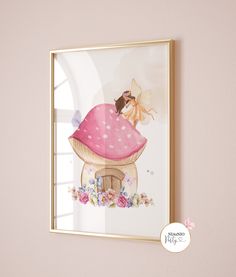 a pink mushroom house with a fairy sitting on it's roof is framed in gold