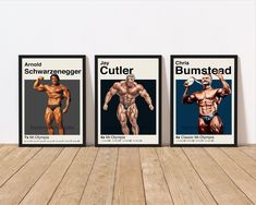 three framed bodybuilding posters on a wooden floor